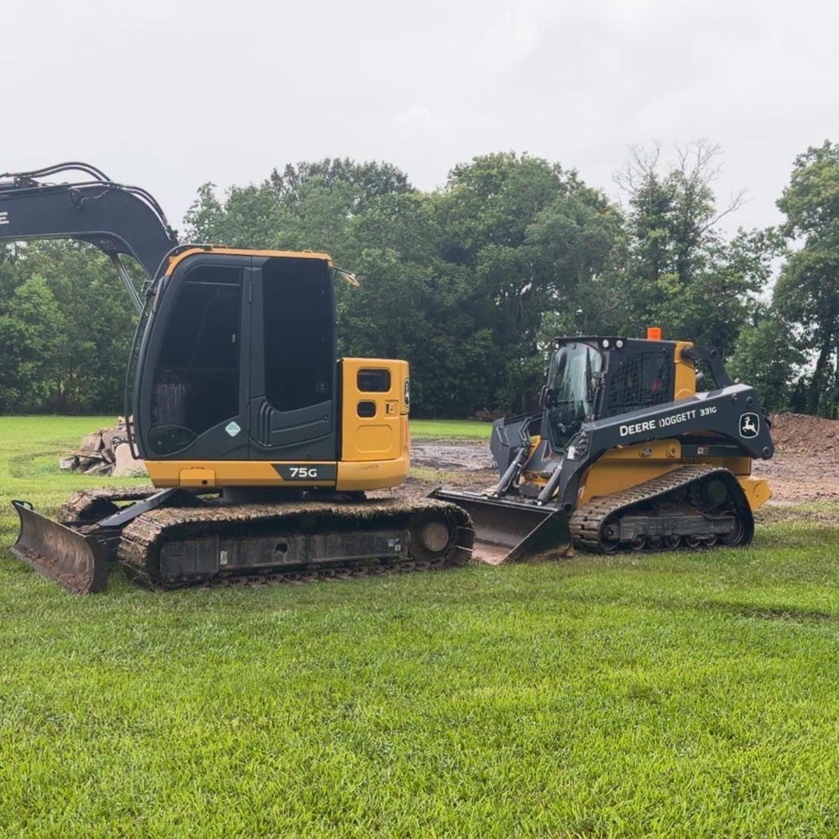 Excavator and John Deere tracked skid steer at a jobsite